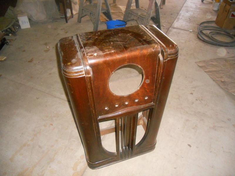 Old wooden radio resting on the floor