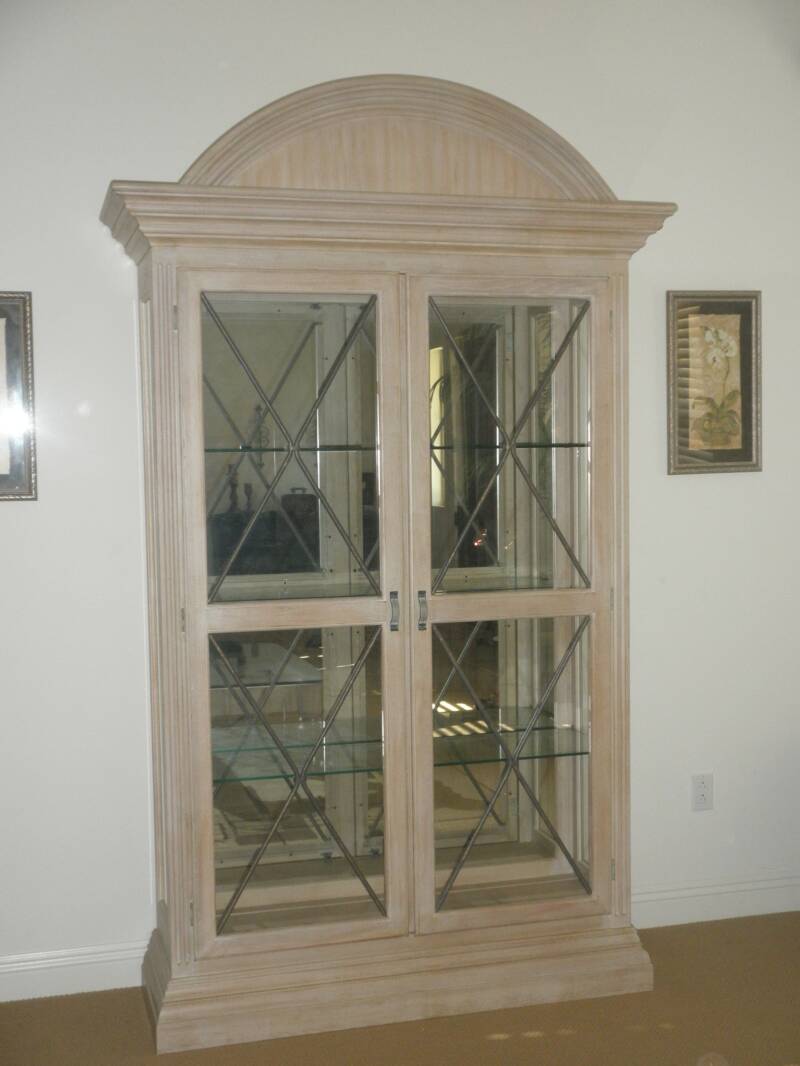 A large wooden cabinet featuring glass doors