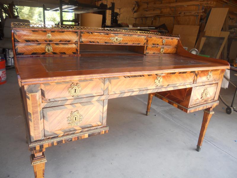 Antique wooden desk featuring a smooth top