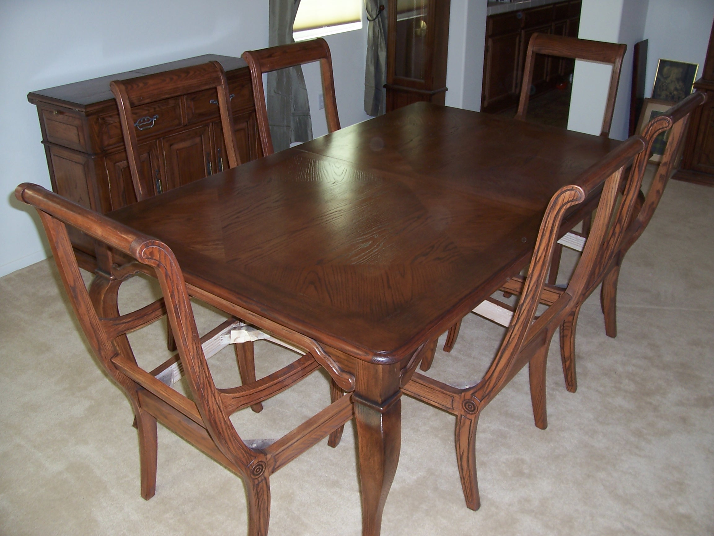 A simple dining room setup featuring a table surrounded by chairs