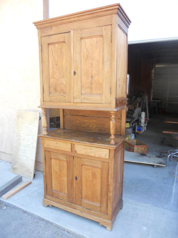 Old wooden cabinet featuring a door and multiple drawers