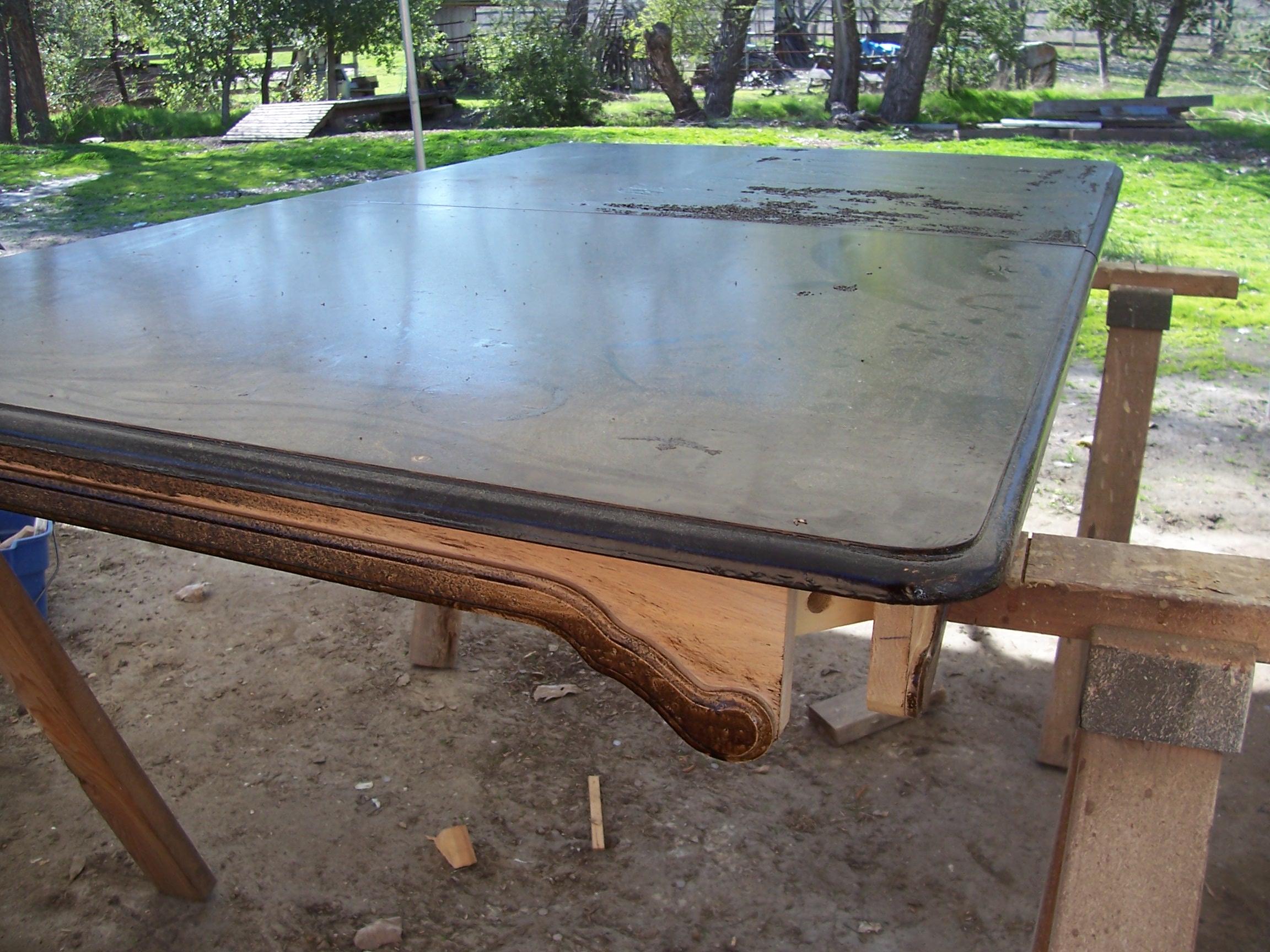 A table placed on a wooden surface, showcasing its design and texture.